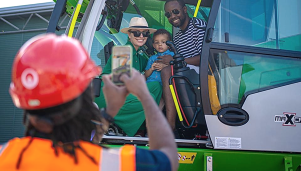 Family in a digger posing for a photo