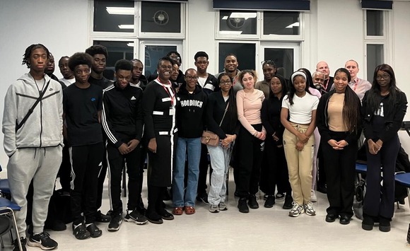 Elevated Minds group shot showing teenagers and adults standing together in a room