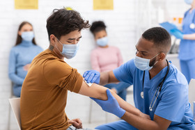 young man getting vaccine 