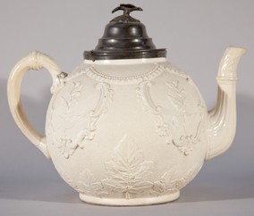 Mrs Hall's Christening Teapot. Large white embossed ceramic teapot with pewter lid.