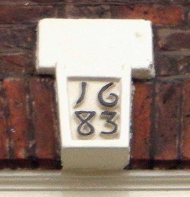 Date stone at Eastgate House - black text on white background reads 1683