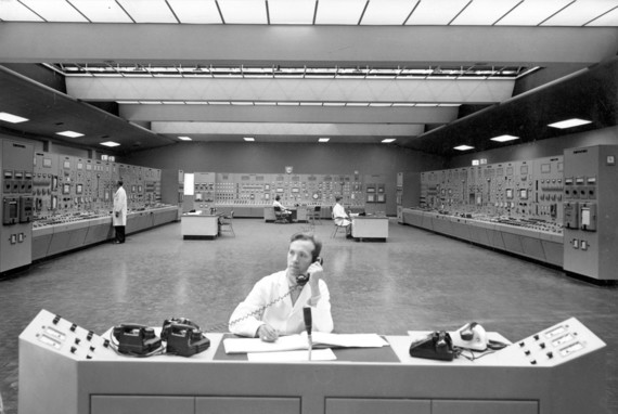 Black and white photograph of interior of Rugeley Power station showing staff working in control room
