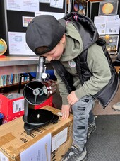 Boy using a telescope