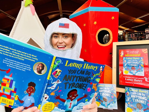 Astronaut holding Lenny Henry's book, 'You can do anything Tyrone'