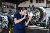 Real life young female aircraft engineer apprentice at work stock photo