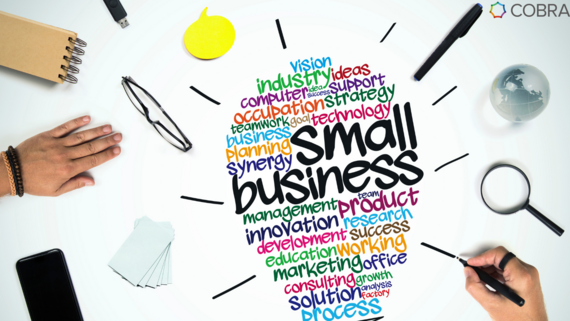 Small Business related words in the shape of a lightbulb, surrounded by stationary