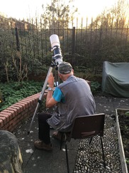 Man looking through a telescope