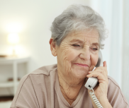 Elderly lady using a landline telephone