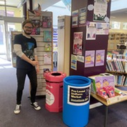 Library Assistant pointing to recycling zone at Cannock Library