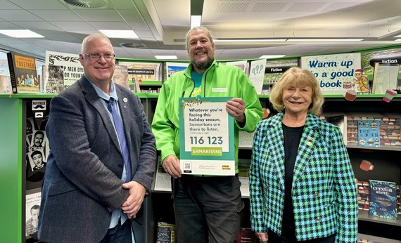 Light up the Longest Night - a group of people holding a Samaritans poster