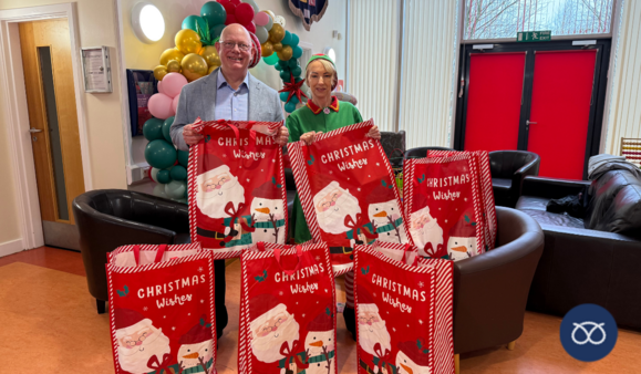 Mark Sutton with Julie Armstrong from A Child’s Heart charity holding christmas gifts