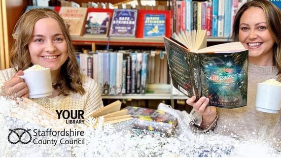 Library staff holding up mugs