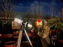 Astronomers looking through a telescope