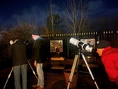 People looking through telescopes