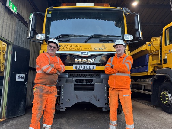 Two highways crew members with a gritter
