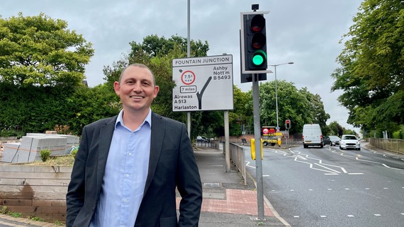 Rob Pritchard, standing underneath a road sign, at Upper Gungate in Tamworth.