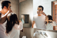 Parent and child brushing teeth