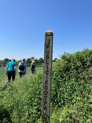 Walkers passing a Public Footpath sign