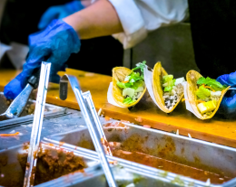 Food vendor preparing tacos