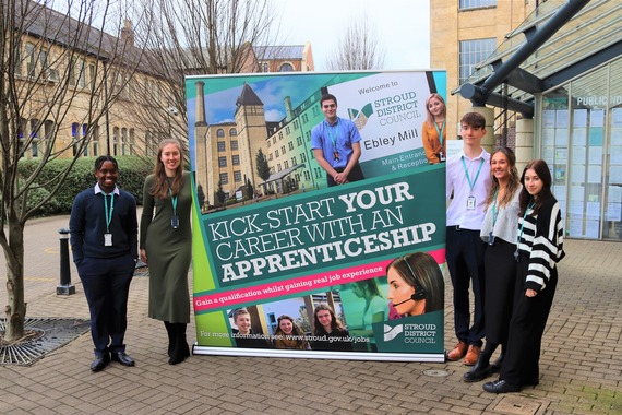 Stroud District Council apprentices with an apprentice banner outside Stroud District Council's HQ 