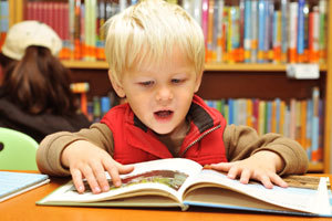 Boy reading in a library
