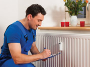 Man bleeding a radiator/housing maintenance 