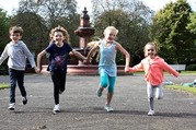 Kids running by fountain