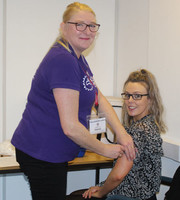 Reanne Mayer receiving a flu jab