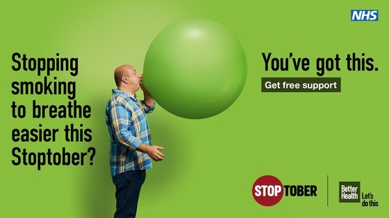 This is an image of a man blowing up a balloon as part of the Stoptober quit smoking campaign