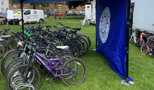 A row of bikes under a gazebo 
