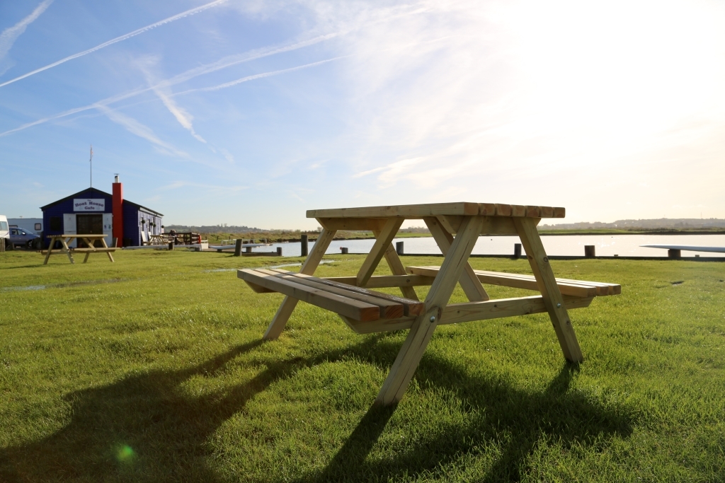 Picnic table and the boathouse at Barton's Point Coastal Park