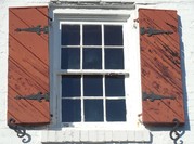 White sash paned window with brown shutters
