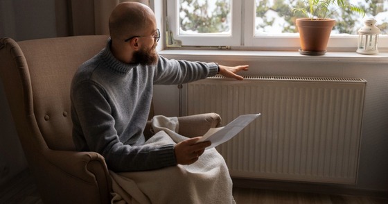 Man holding radiator and paper