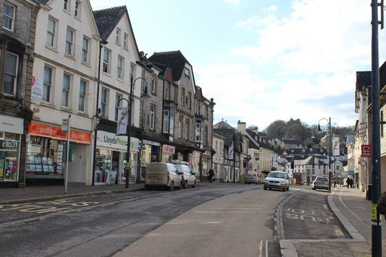 high street with shops and cars