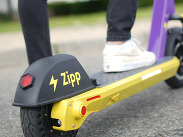 Close up of the rear end of a Zipp Mobility-branded e-scooter.