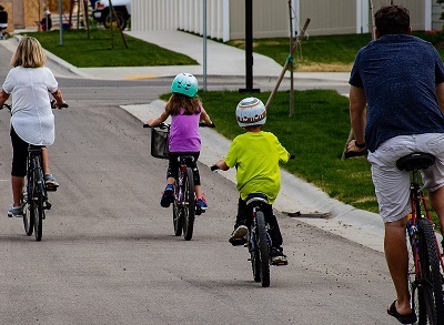 Two adults and two children cycling