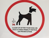 PSPO sign warning people to clear up after their dogs or face fines or prosecution 