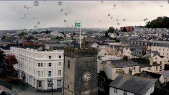 Image from Teignbridge climate change video, bubbles with CO within them rising above a town setting