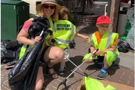 Lady and two children taking part in volunteer carbon reduction initiative