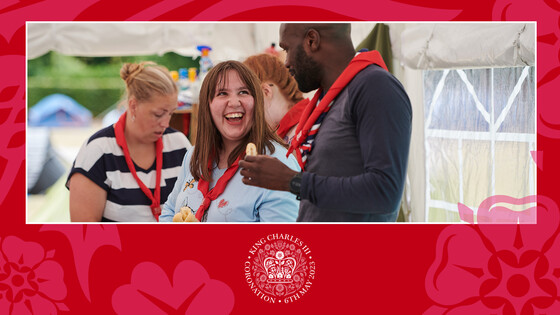 Person laughing while talking to another with two people in background  Coronation crest