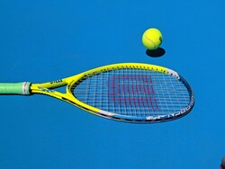 tennis racquet and yellow ball