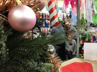 Festive market image with Christmas tree and traders in background