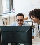 Two people looking at a computer screen