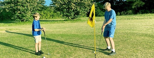 Two boy playing golf