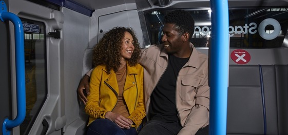 Two people on a night bus