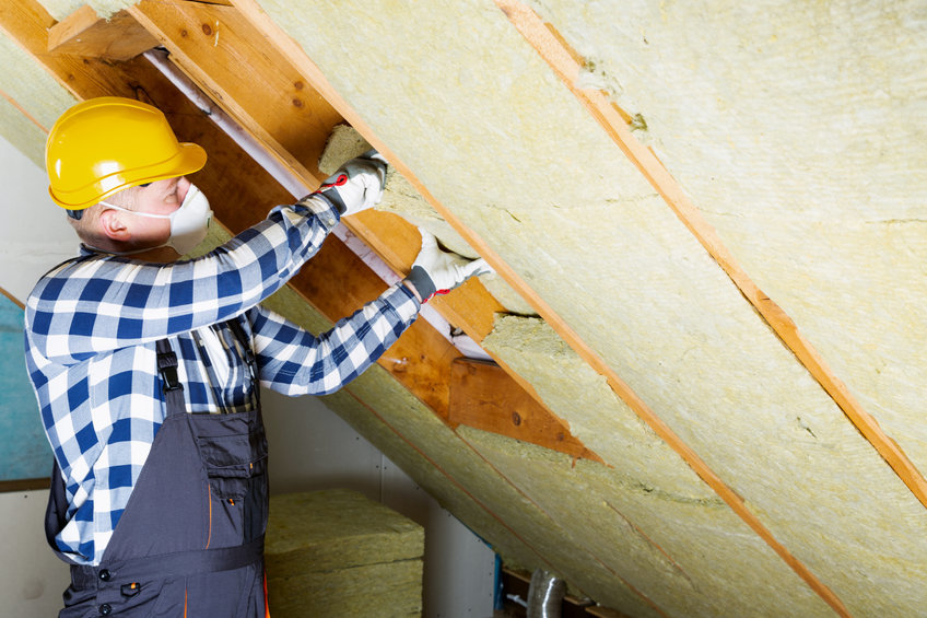 Loft Insulation pic - person installing loft insulation