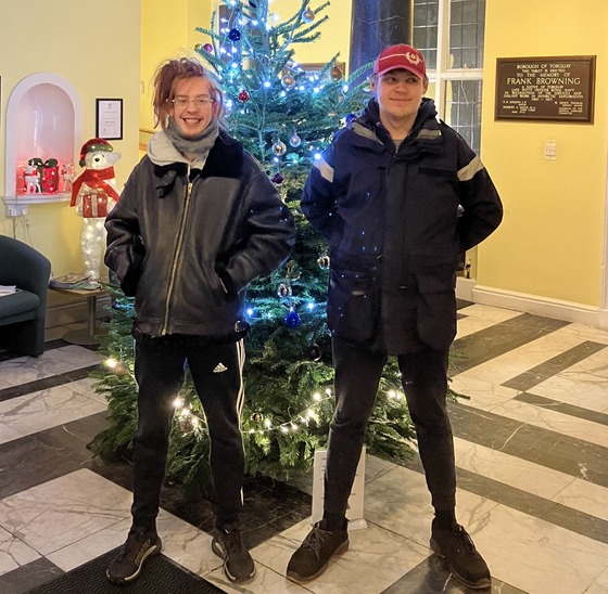 Young people in front of Christmas tree at town hall
