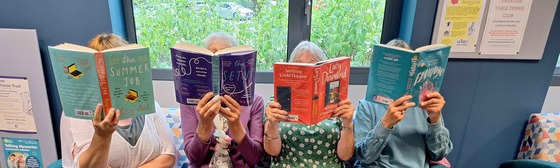 Photograph of people at the library reading