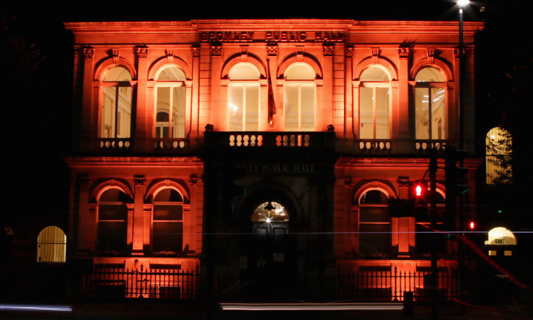 Photograph of Bromley Public Hall lit up in orange