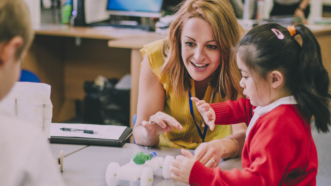 Teacher with their pupil in a classroom